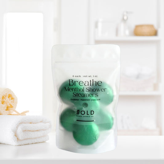 Breathe aromatherapy shower steamers with eucalyptus and peppermint beside clean spa bathroom decor