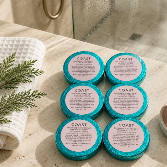 6 shower steamers wrapped in teal foil on bathroom counter