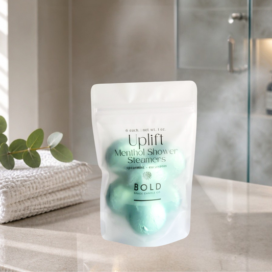 Pack of Uplift Menthol Shower Steamers on a bathroom counter with a blurred background