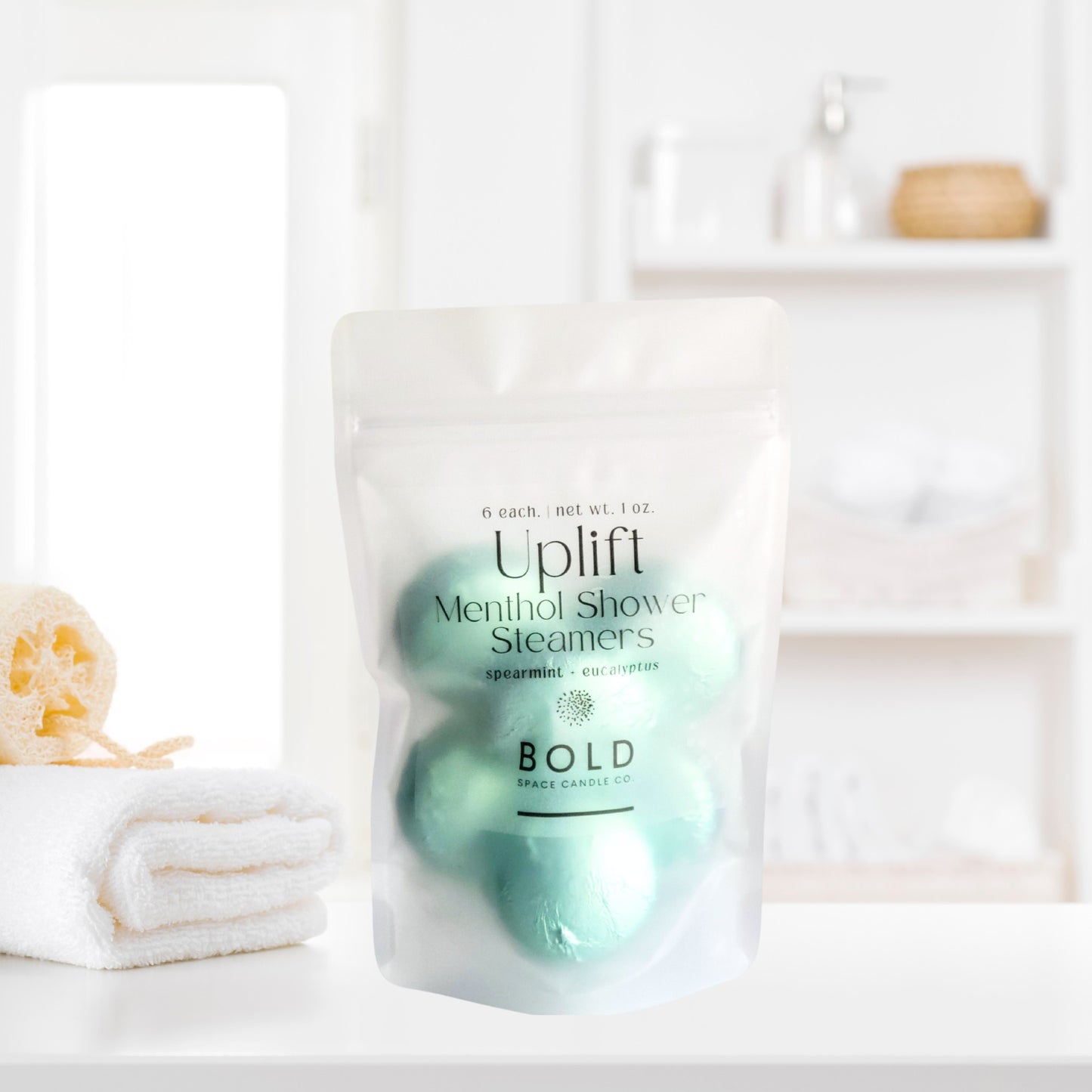 Uplift aromatherapy shower steamers styled in bright spa bathroom setting