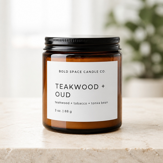 Candle jar with 'Teakwood + Oud' label on a neutral background