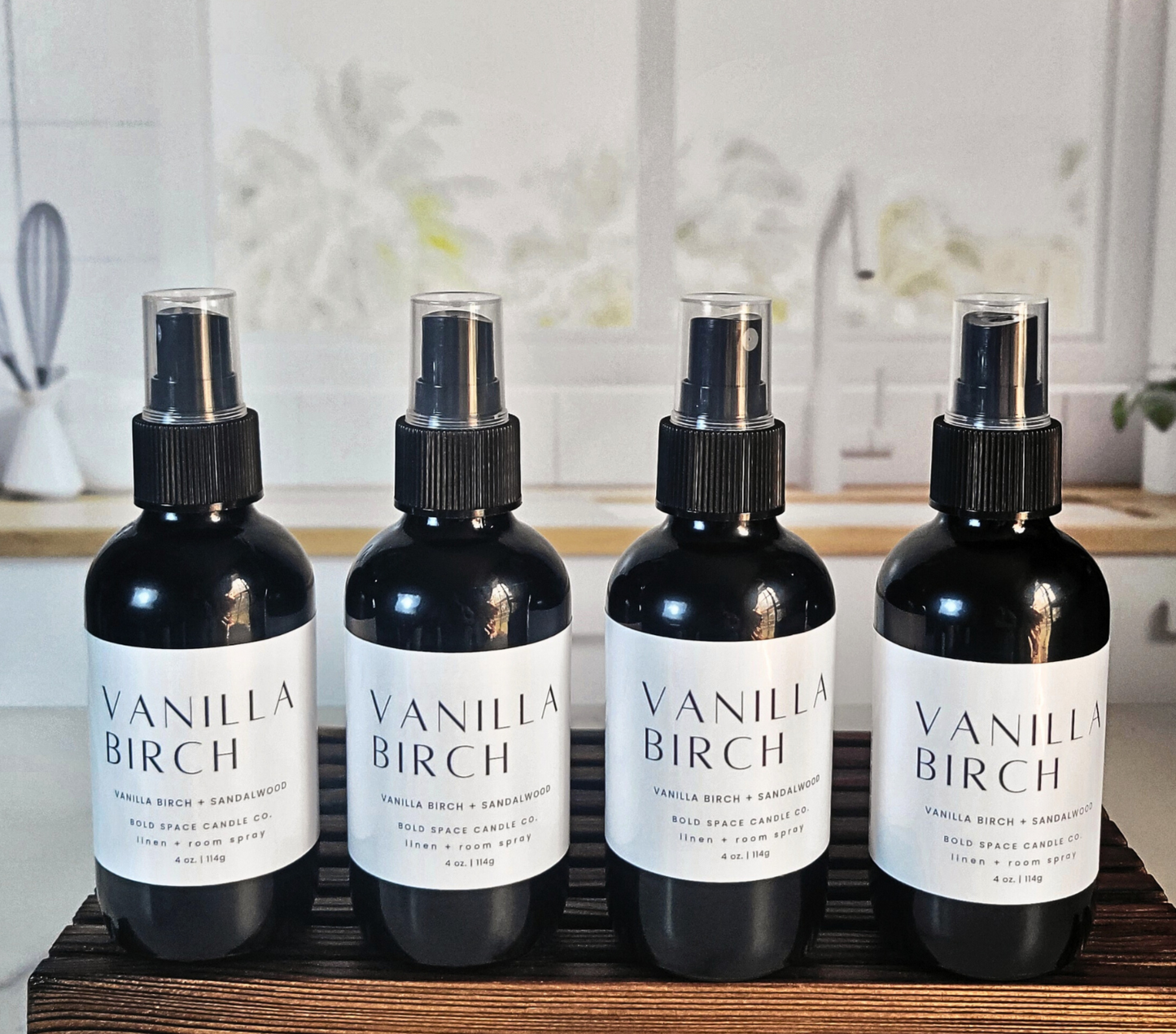 Four black bottles of Vanilla Birch - Linen & Room Spray, showcasing the product 'vanilla birch room spray' in a stylish setting.