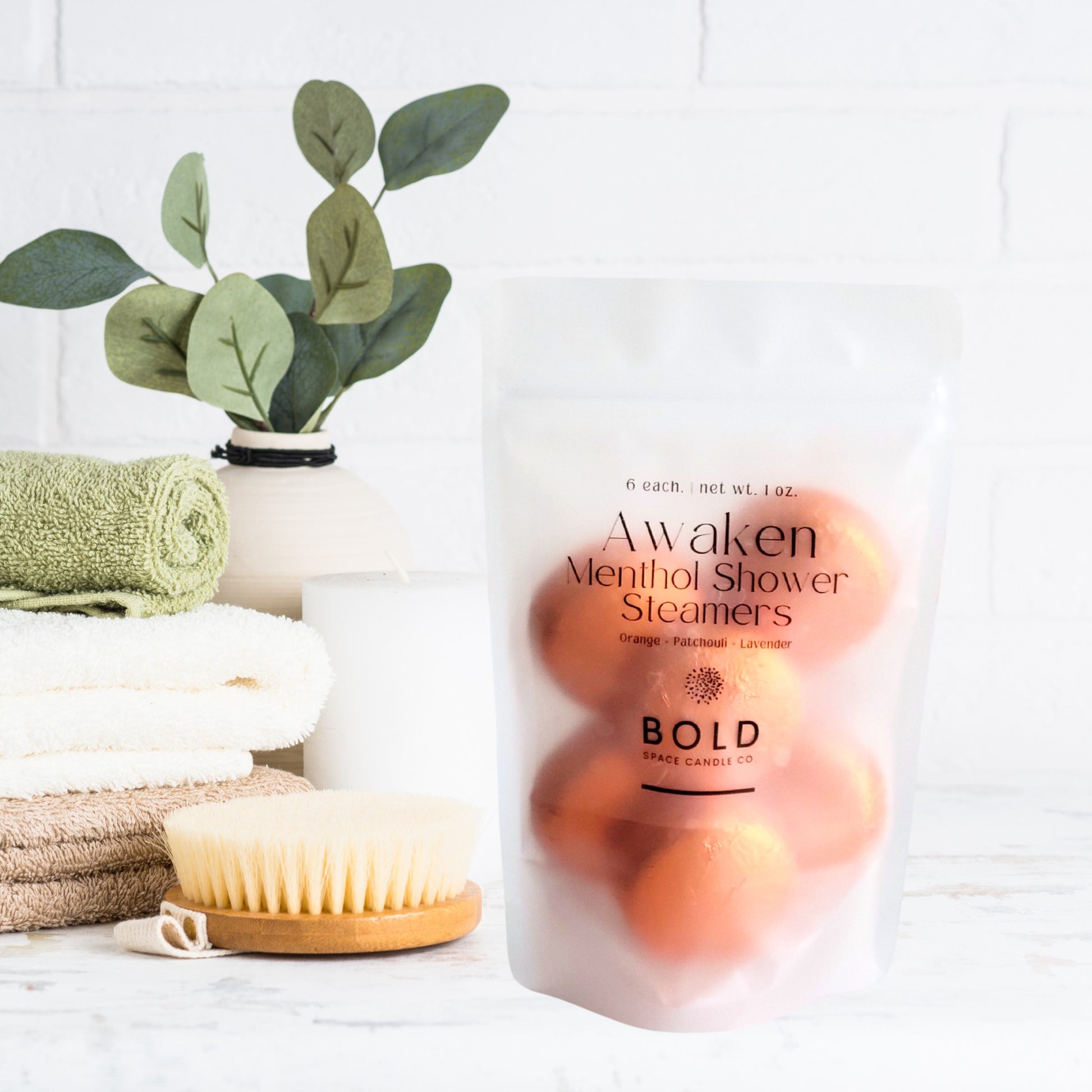 Awaken menthol shower steamers with orange, lavender, and patchouli in frosted pouch