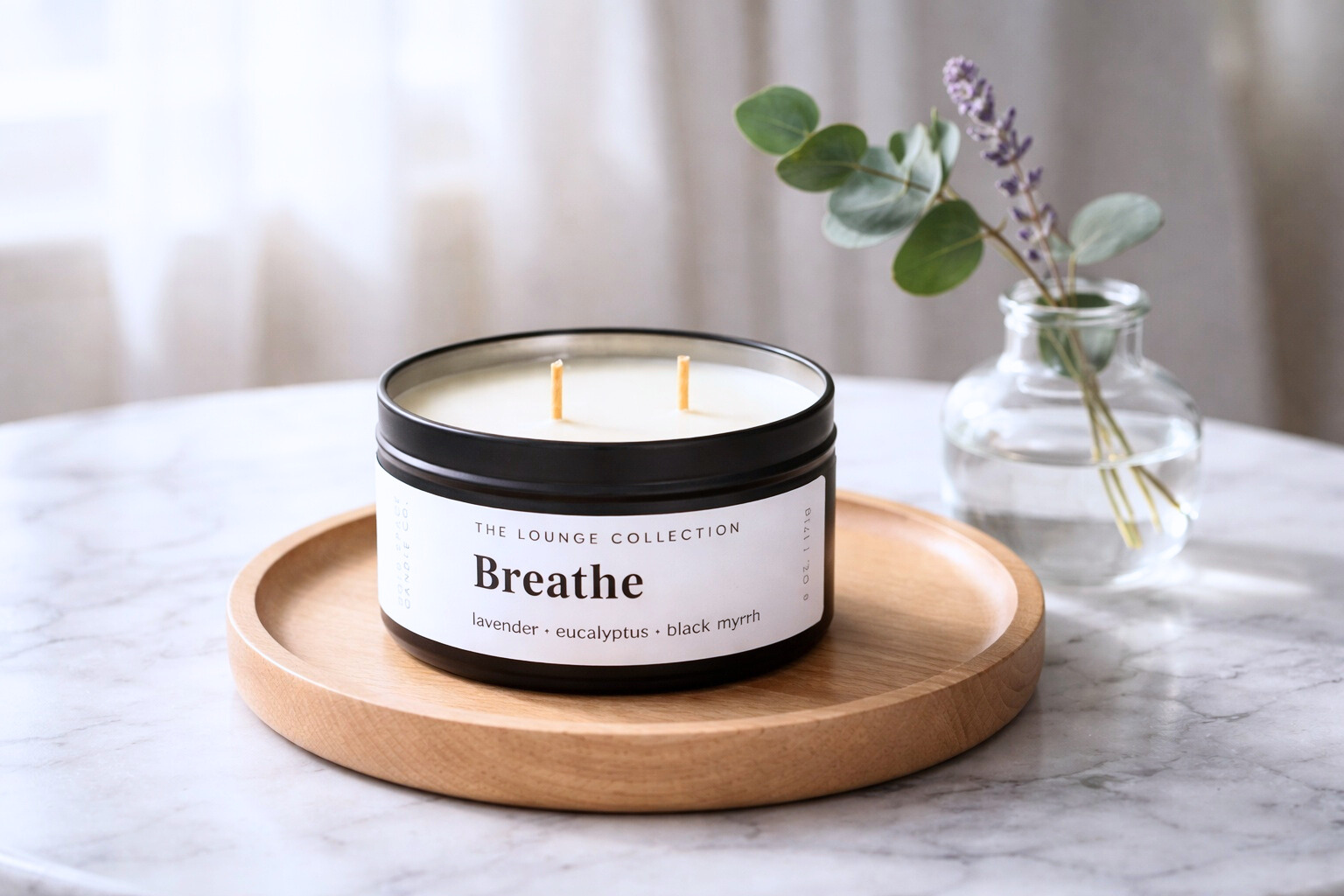 Candle labeled 'Breathe' on a wooden tray with a blurred background