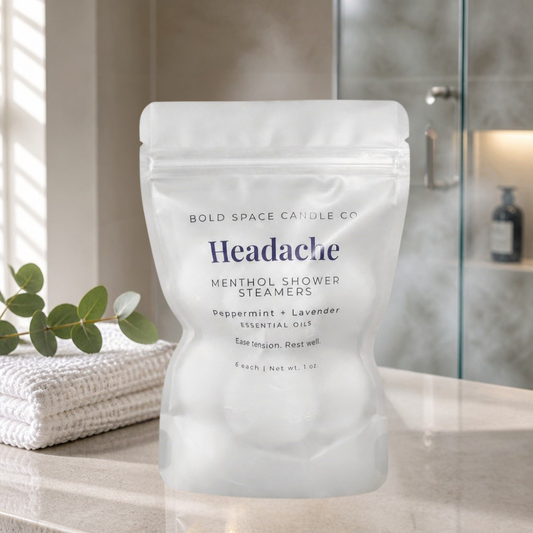 Pack of Bold Space Candle Co. Headache Menthol Shower Steamers on a bathroom counter.
