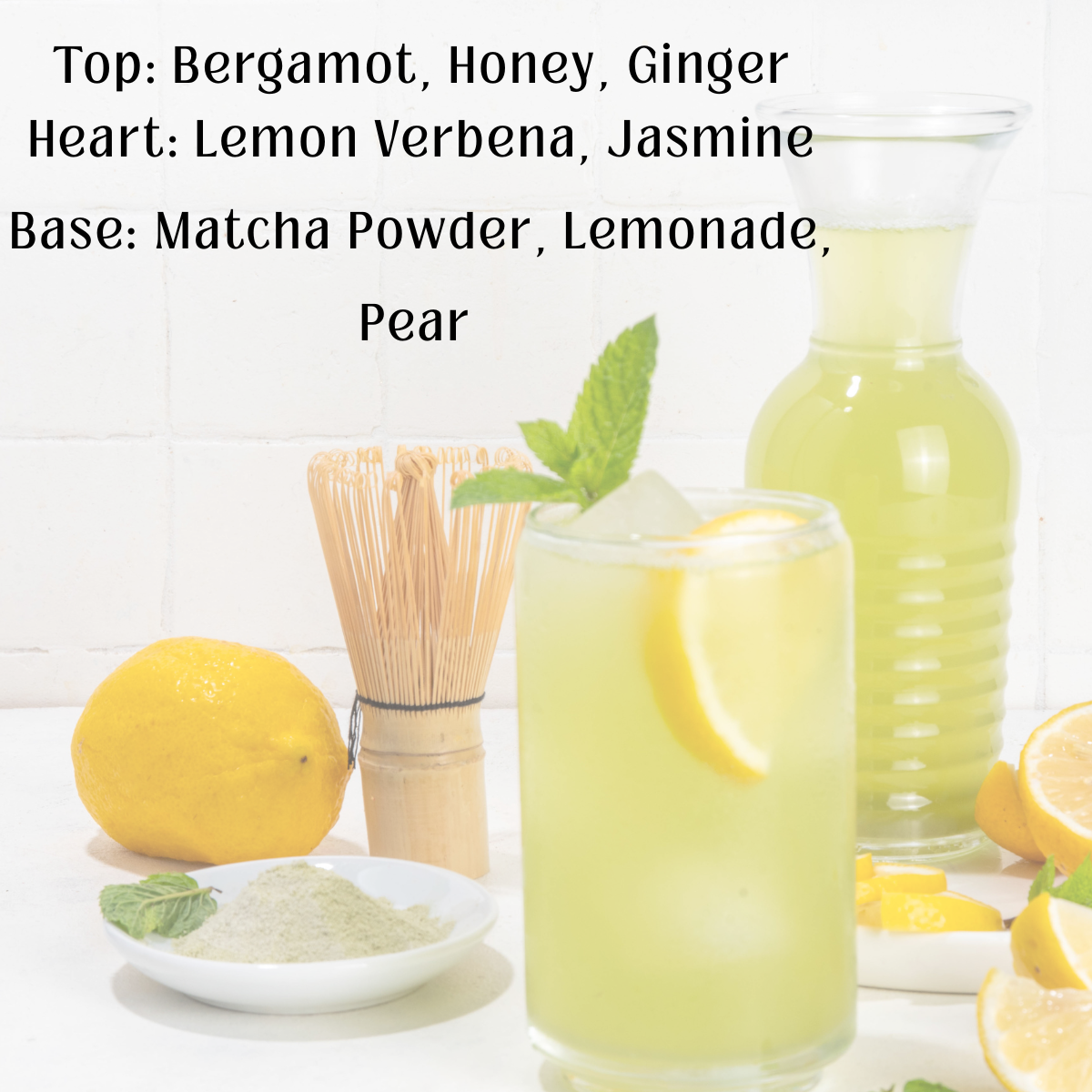 Glass of lemonade with a pitcher, lemons, and matcha powder on a white background.