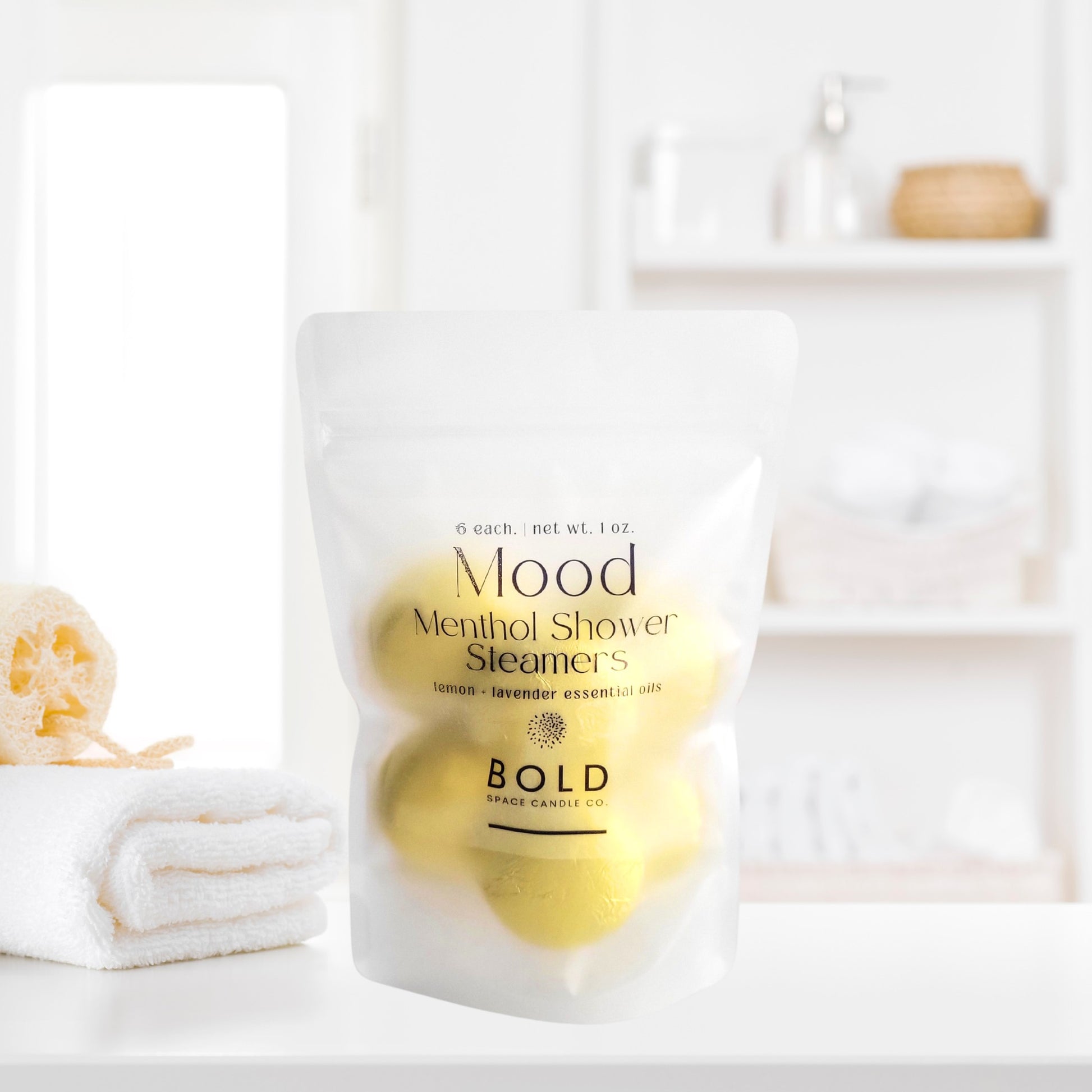 Lemon and lavender shower steamers styled in clean modern spa bathroom setting