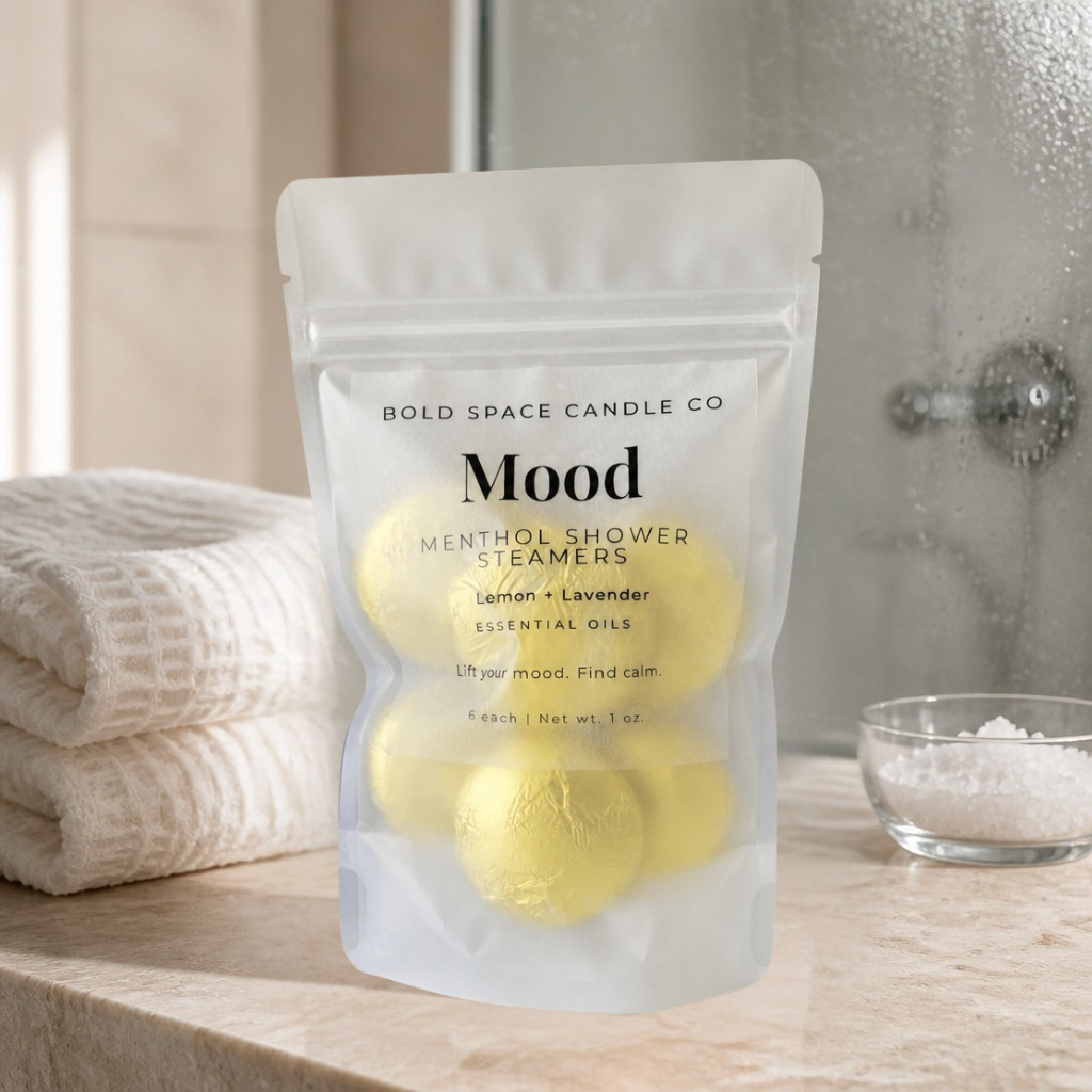 Menthol shower steamers in a clear packaging labeled 'Mood' by Bold Space Candle Co on a bathroom counter.