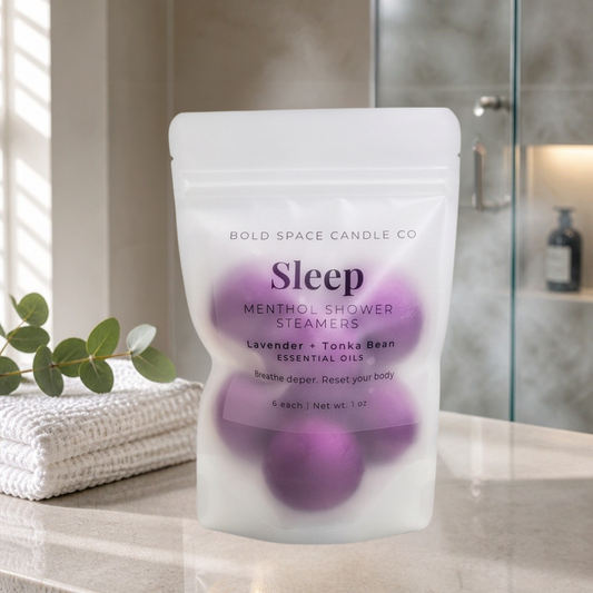 Pack of Sleep menthol shower steamers on a bathroom counter with a blurred background