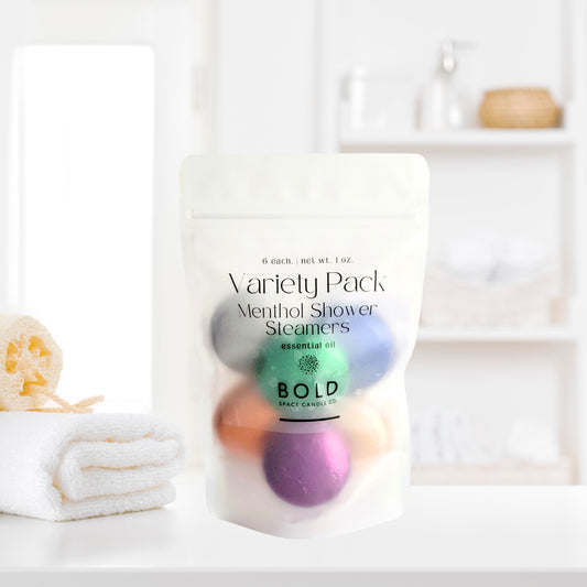 Variety Pack aromatherapy shower steamers styled in clean spa bathroom setting with self-care essentials