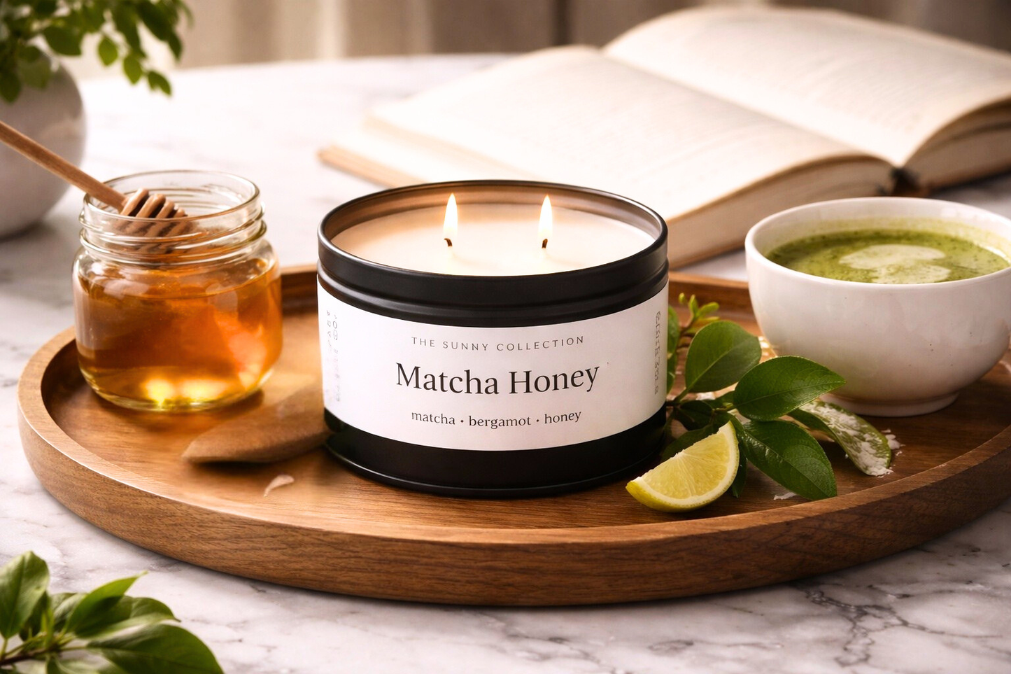 Matcha Honey candle on a wooden tray with honey, a bowl of matcha, and a book in the background.