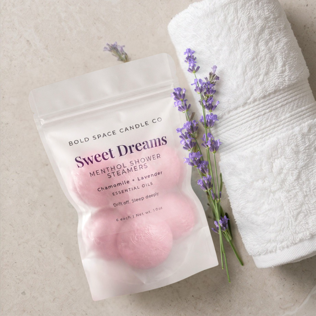 Sweet Dreams menthol shower steamers with lavender and chamomile, wrapped in a white space candle co packaging on a beige background.